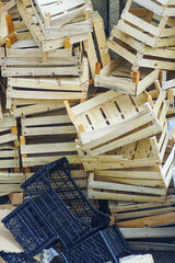 Mountain of discarded fruit boxes and shipping crates awaiting processing for recycling programs....