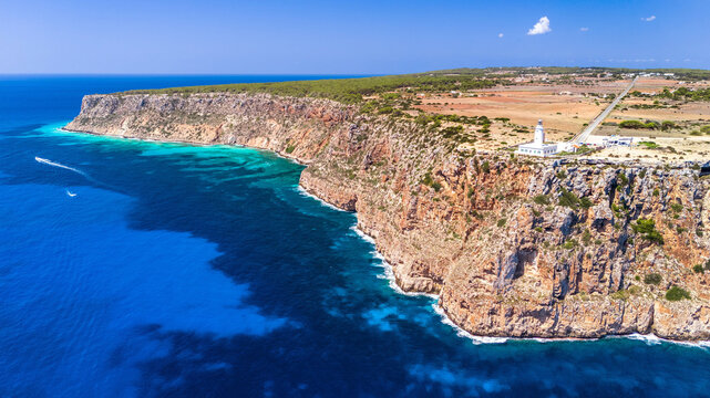 A aerial view of lighthouse of La Mola in Balearic island of Formentera. With the coast and turquoise water.