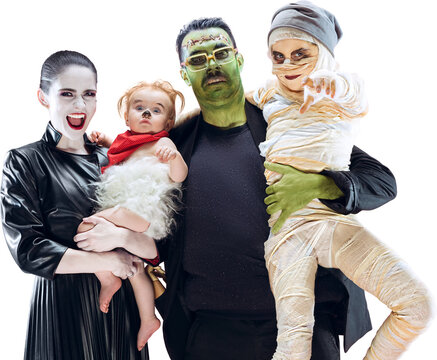 Family Halloween portrait with vampire mother, Frankenstein father, mummy child, and baby monster. Concept of spooky celebration, family costumes, and festive masquerade. Transparent background