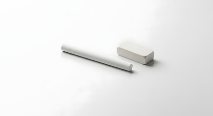 A piece of white chalk lies next to a white eraser on a clean, bright white surface.