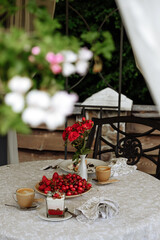 Romantic breakfast table setting with fresh fruit and coffee