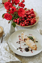 Breakfast with strudel, berries, and flowers