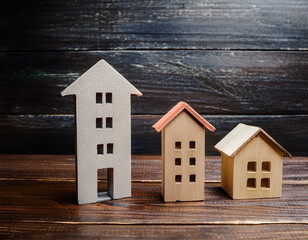 Miniature Wooden Houses Standing Together With Warm Light Accent