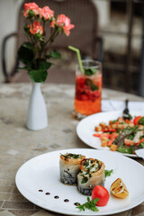 Delicious seafood rolls with fresh ingredients on a white plate.