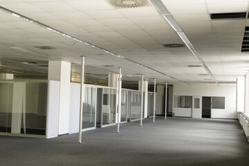 Spacious, vacant office with glass partitions, ideal for real estate, architecture, and business concepts.
