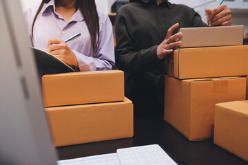 Portrait of Starting small businesses SME owners, two Asian woman check online orders Selling...