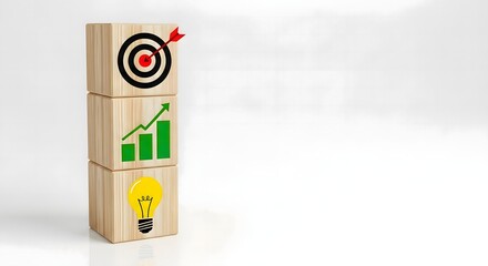 Wooden blocks stacked with target chart and lightbulb icons against a white background surface area