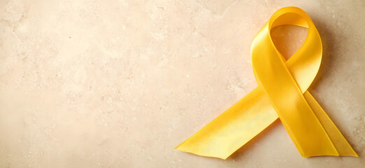 Yellow ribbon on flat yellow background, symbolizing cancer awareness with copy space for health campaigns and design use
