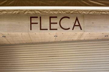 Closed shutters of a business with the Fleca sign.