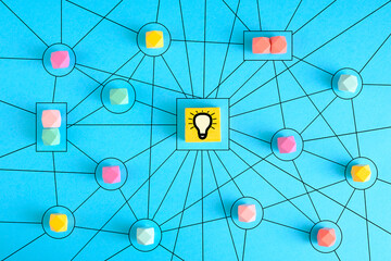 Business concept networking with members connected to each other. Communication, teamwork, community, society. Abstract concept with wooden pieces on blue background. Stock photo.