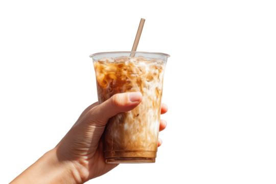 Hand holding an iced coffee in a tall clear plastic cup, transparent background