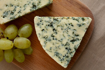 Delicious Cheese Danablu on a wooden board, top view. Close-up.