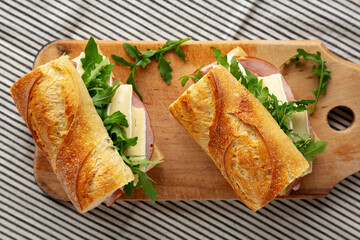 Homemade French Ham and Brie Baguette with Arugula Greens, top view.