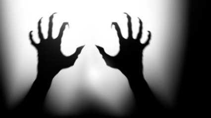 Shadow overlay effect for halloween background with Terrifying scary hands with long nails,Creepy monster claw,silhouette of hands,zombie hand rising out of a graveyard