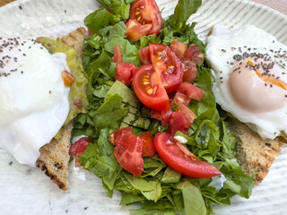 healthy breakfast with poached eggs  and salad
