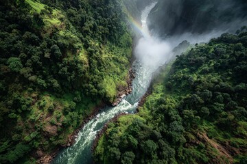 Majestic river flows through lush green valley with mist and rainbow in vibrant landscape