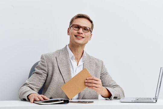 smiling man using laptop digital nomad casual wear eyeglasses sitting at table work remote video call white background