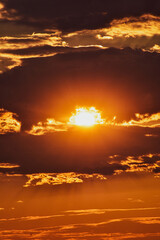 Magical sky at dusk with fiery light and smoky clouds