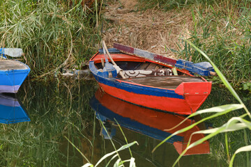 Red and blue boats on the Nile River in Egypt. Shallow depth of fiel
