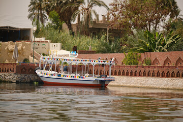 Luxor, Egypt- August 13, 2025: Colorful tourist boats on the Nile River in Egypt. 