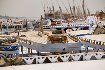 Luxor, Egypt- August 13, 2025: Colorful tourist boats on the Nile River in Egypt. Old lifebuoys. Shallow depth of field