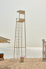 An empty lifeguard tower on the seashore.