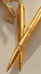 Golden pens on a light beige background