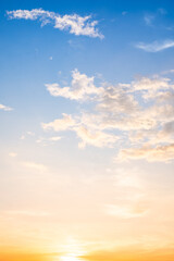 Obraz premium Beautiful , luxury soft gradient orange gold clouds and sunlight on the blue sky perfect for the background, take in evening,Twilight, Large size, high definition landscape photo,Vertical