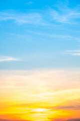 Obraz premium Beautiful , luxury soft gradient orange gold clouds and sunlight on the blue sky perfect for the background, take in evening,Twilight, Large size, high definition landscape photo,Vertical