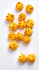 Golden puffs arranged on white surface