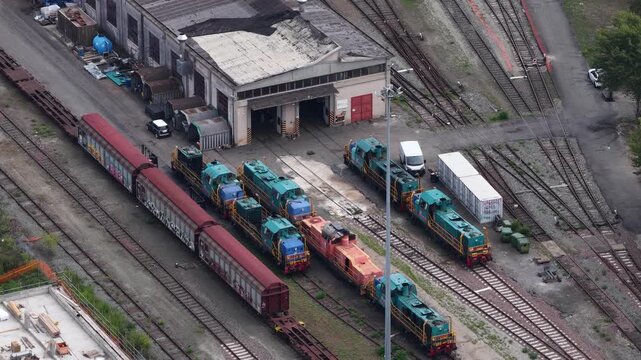 Aerial footage of Locomotives at the Turin Orbassano intermodal terminal with a warehouse