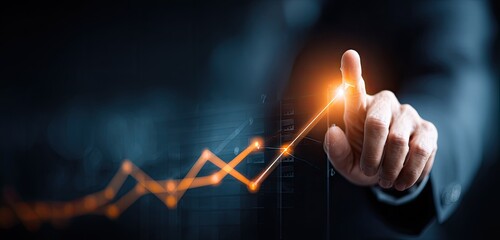Business growth concept with hand pointing at rising graph.