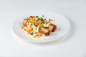 quinoa with meat in a white plate sprinkled with vegetables on a white background