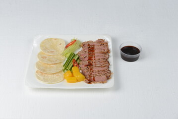 taco assemble yourself in a plate pita bread meat pepper on a white background with sauce