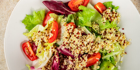 Quinoa salad tomato, green leaf salad vegetables dish natural product tasty snack fresh gourmet food background on the table rustic top view copy space keto and paleo diet vegan and vegan food