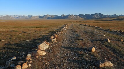 The sunset falls behind the mountains, and before me is the autumn brown grassland, with white clouds floating in the blue sky, calm, contemplative, vast, magnificent, and beautiful.