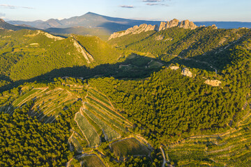 Aerial view of dramatic sunset above Gigondas and Les Dentelles de Montmirail vineyards at the Mont...