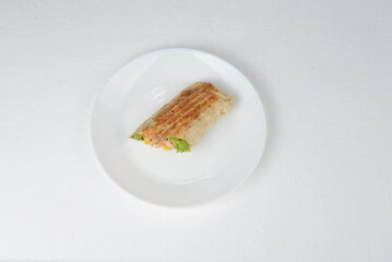 fajito with chicken and vegetables in a white plate on a white background