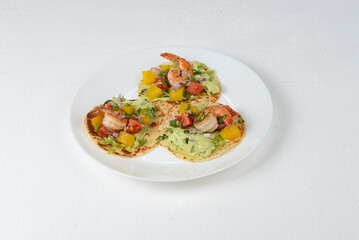 Shrimp tacos on a white plate
