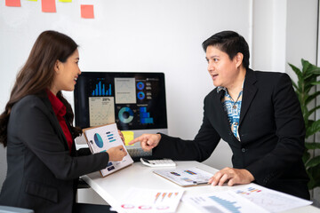 Business colleagues discussing financial charts and data analysis in office meeting