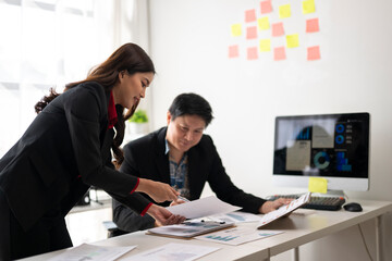 Business people working together in modern office analyzing charts and reports