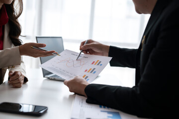 Business people analyzing statistics discussing financial results holding chart