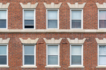 Classic red brick facade with orderly windows revealing timeless urban residential architecture in Cambridge, Massachusetts, USA
