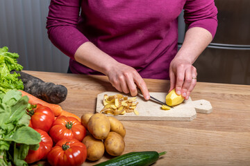 Woman Preparing a Healthy Meal with Fresh Vegetables in the Kitchen