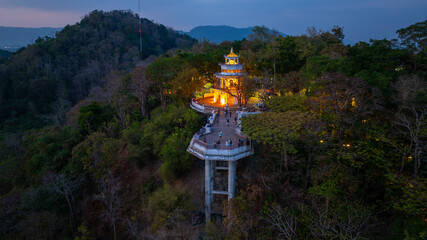 Aerial view of scenery Khao Rang viewpoint at twilight.
view of a town nestled among lush green mountains at sunset, with a Pavilion structure perched on the hillside at Phuket town at Dusk