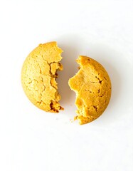 Broken round cookie on white surface
