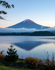 Majestic mountain reflected in calm lake at dawn