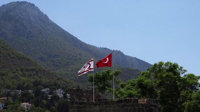 Flags of Turkey and Northern Cyprus are waving over Bellapais Abbey, North Cyprus