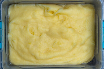 Mashed potatoes in plastic food container. Dish of smooth potato puree in plastic box, closeup, top view