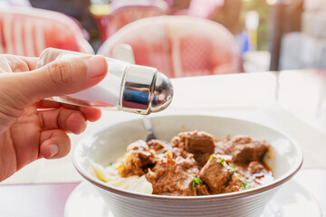 Adding salt to food concept, unhealthy habit linked to diseases and health risks